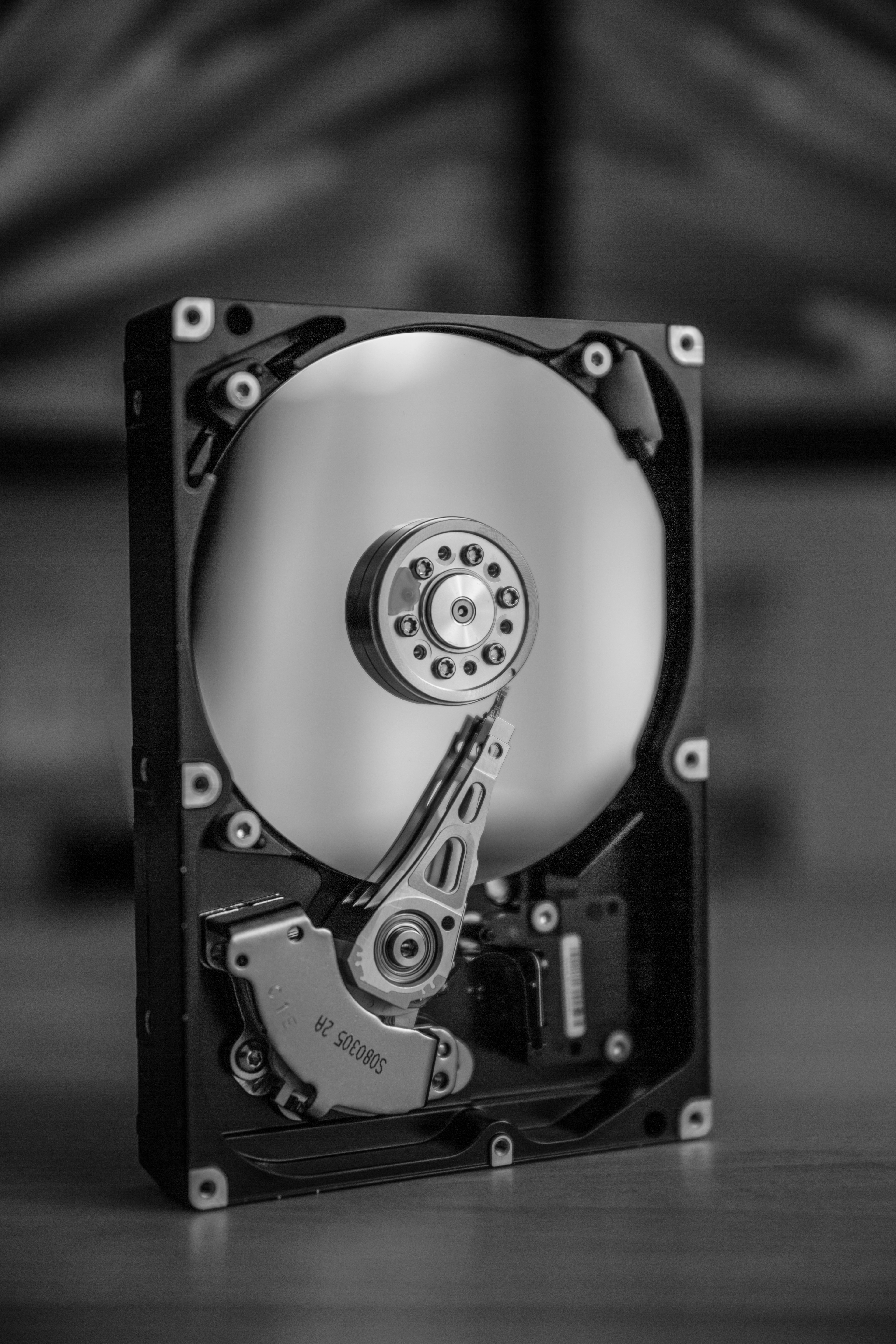 Stack of enterprise hard disk drives showing metallic platters and read-write heads